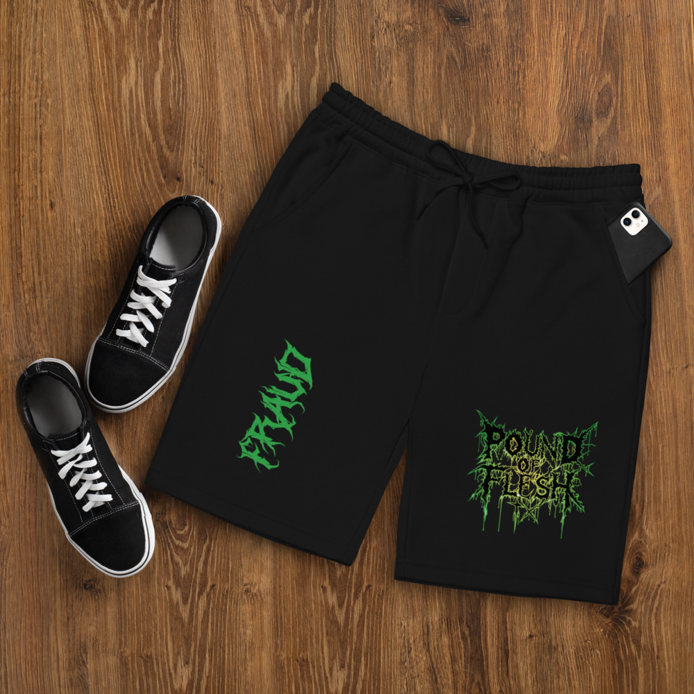 Black shorts with th ePound of Flesh TX logo outlined in green and yellow on the left leg, and the word Fraud in a gothic fint on the right leg